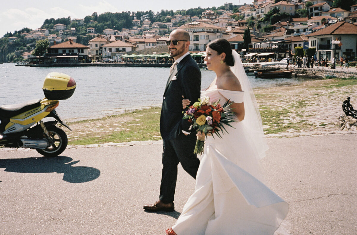 A bride and groom walking in Old Town, Lake Ohrid Wedding, North Macedonia