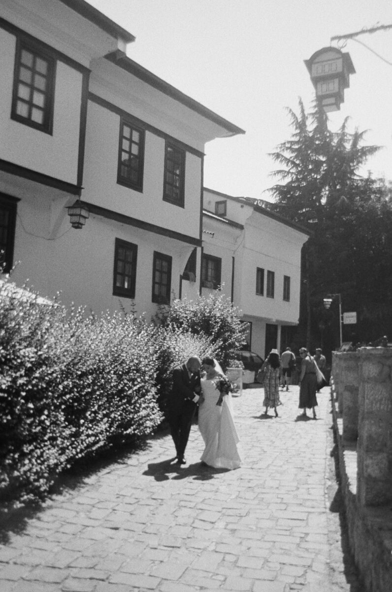 A bride and groom walking in Old Town, Lake Ohrid Wedding, North Macedonia